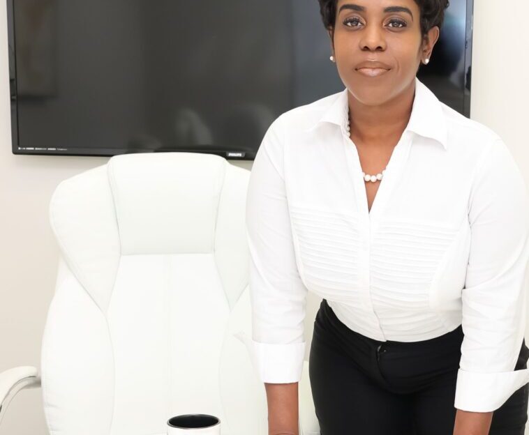 Woman standing by white office chair.