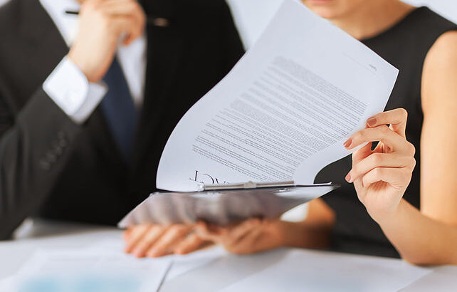 Two people reviewing a document together.